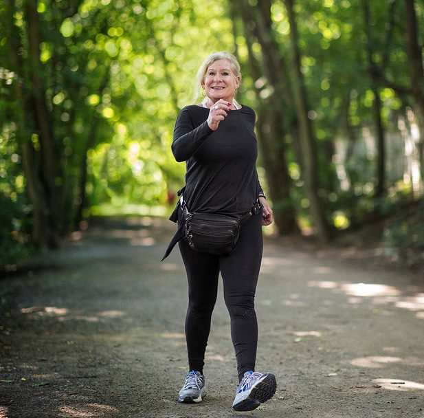Patient Sharyn Shell, 67, walking along a path outdoors in Toronto