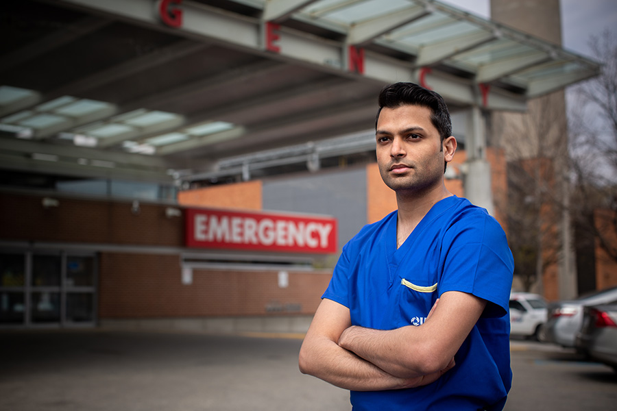 Photo of Dr. Sameer Masood standing outside of emergency department gazing off into the distance 