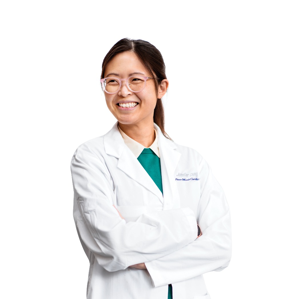 Dr. Jennifer Chung wearing a lab coat, she is looking over her right shoulder and smiling with a wide grin.